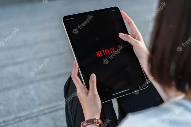 Women uses netflix app on smart phone screen. Premium Photo